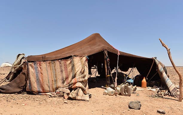 Original, nomadic tent made of camel wool, on a stony Sahara desert in Morocco.